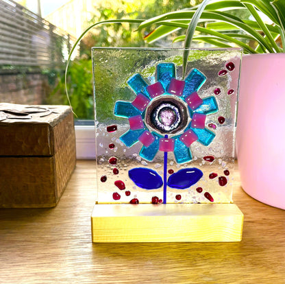 Turquoise and pink fused glass flower with bright dichroic centre