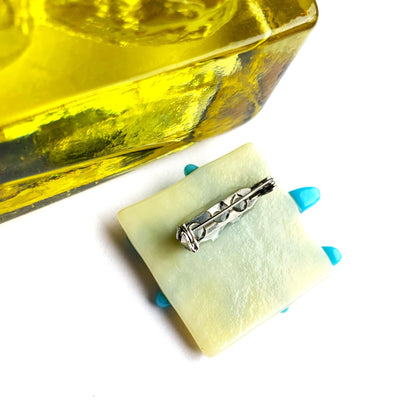 Blue flower fused glass brooch with an iridescent teal centre and green aventurine sparkle