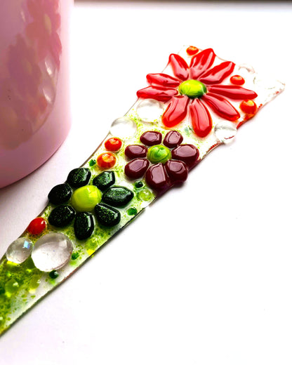 Red glass flower plant stake in outdoor plant pot