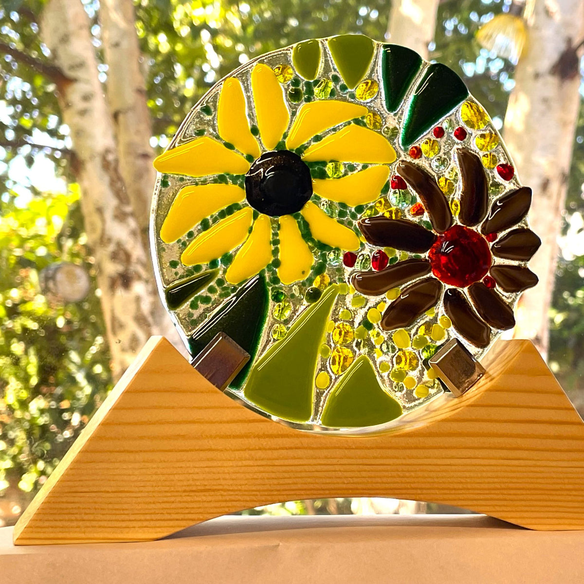 Close-up of the brown flower, yellow glass, green leaves and aventurine sparkle