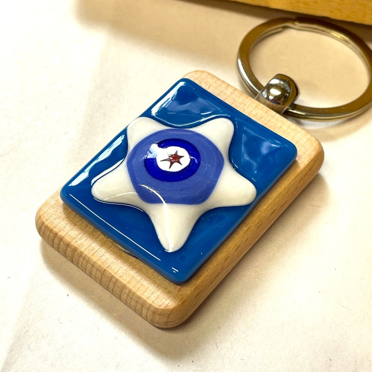 Back of a handmade wooden keyring showing the keyring loop