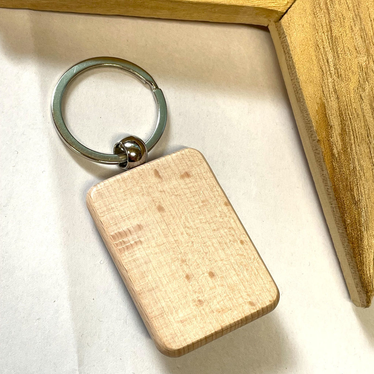 Angled view of a star fused-glass keyring with a wooden base