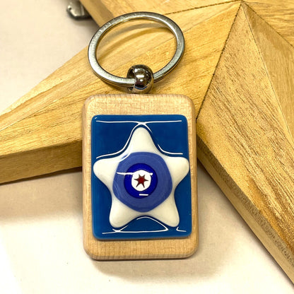 Red, white and blue star fused-glass keyring on a wooden base