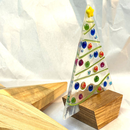 Fused-glass Christmas tree sitting securely in its oak wooden base